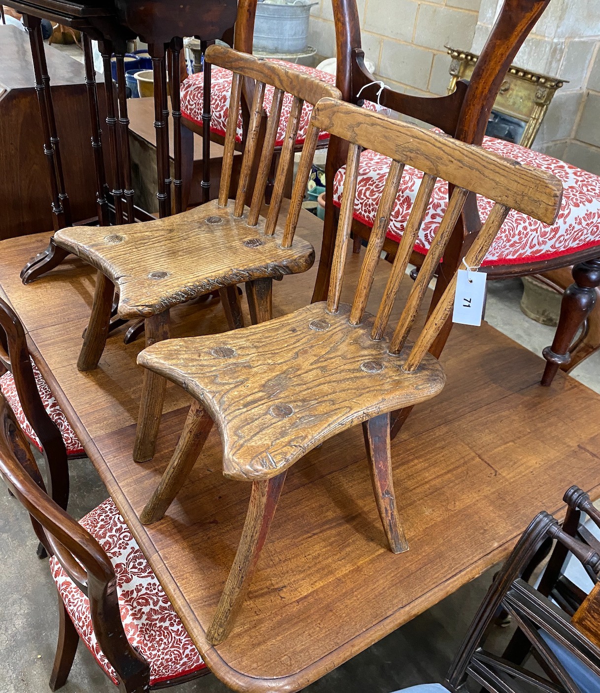 A near pair of 19th century primitive ash and elm Windsor child's chairs, larger width 34cm, depth 39cm, height 63cm